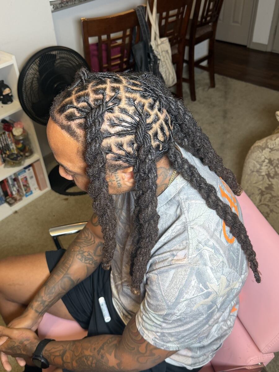 Diamond parted locs styled back, overhead view
