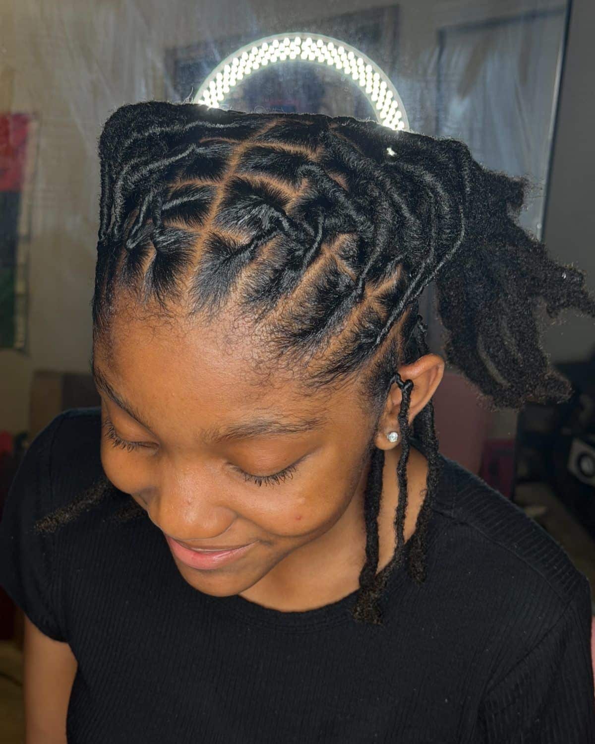 MomoLocs client smiling with a fresh loc retwist styled into an updo
